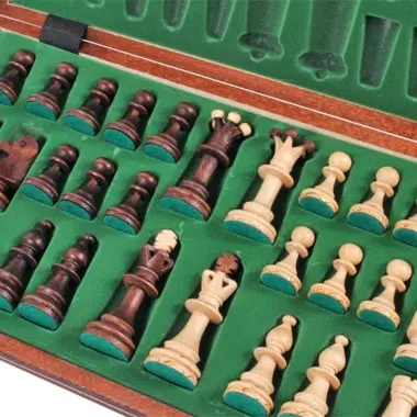 Schachfiguren diagonal angeordnet in der mit grünem Filz ausgekleideten Box
